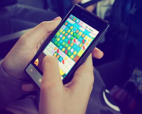 Main smartphone showing a fictional CROWN game interface